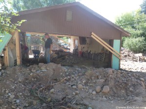 Chris and Misti starting the cleanup in Ed's garage, the river deposited all the rocks and mud here (and throughout town), 9/29/13.