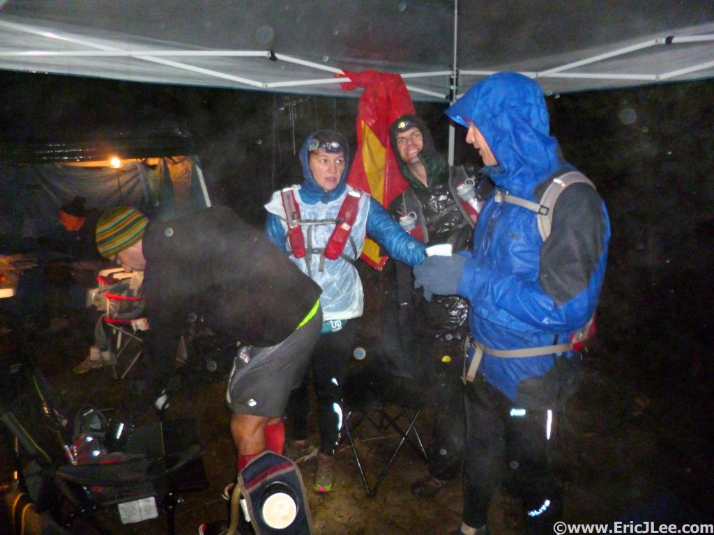 Jason and other runner hunkered down under our small tarp at Gibson Basin as the rain pounds us. No one was dry, but the Aid Station workers were still awesome.