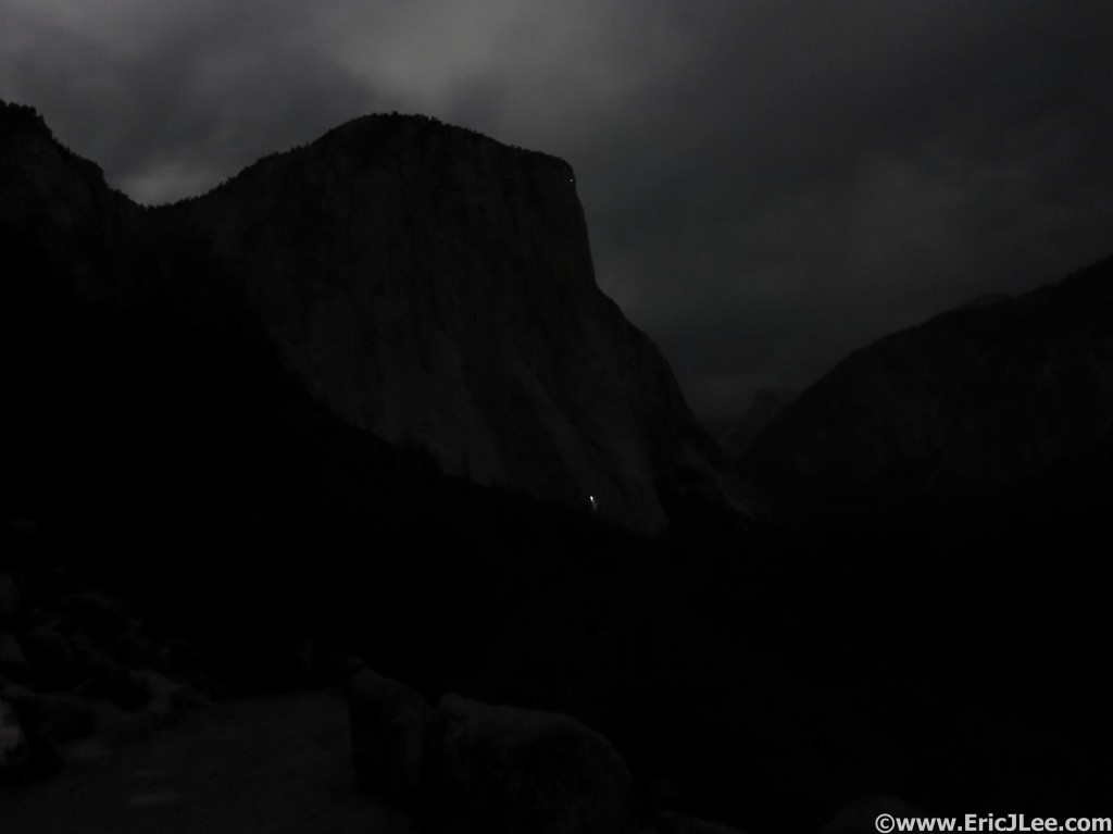 El Cap in the moonlight with a solitary headlamp bivied on the wall.